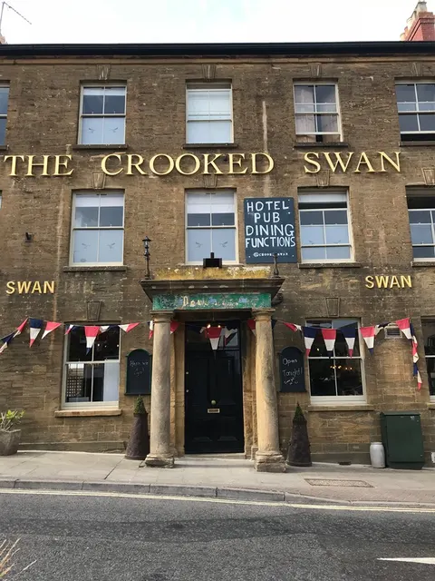 The Crooked Swan pub frontage on Church Street, Crewkerne, hung with bunting