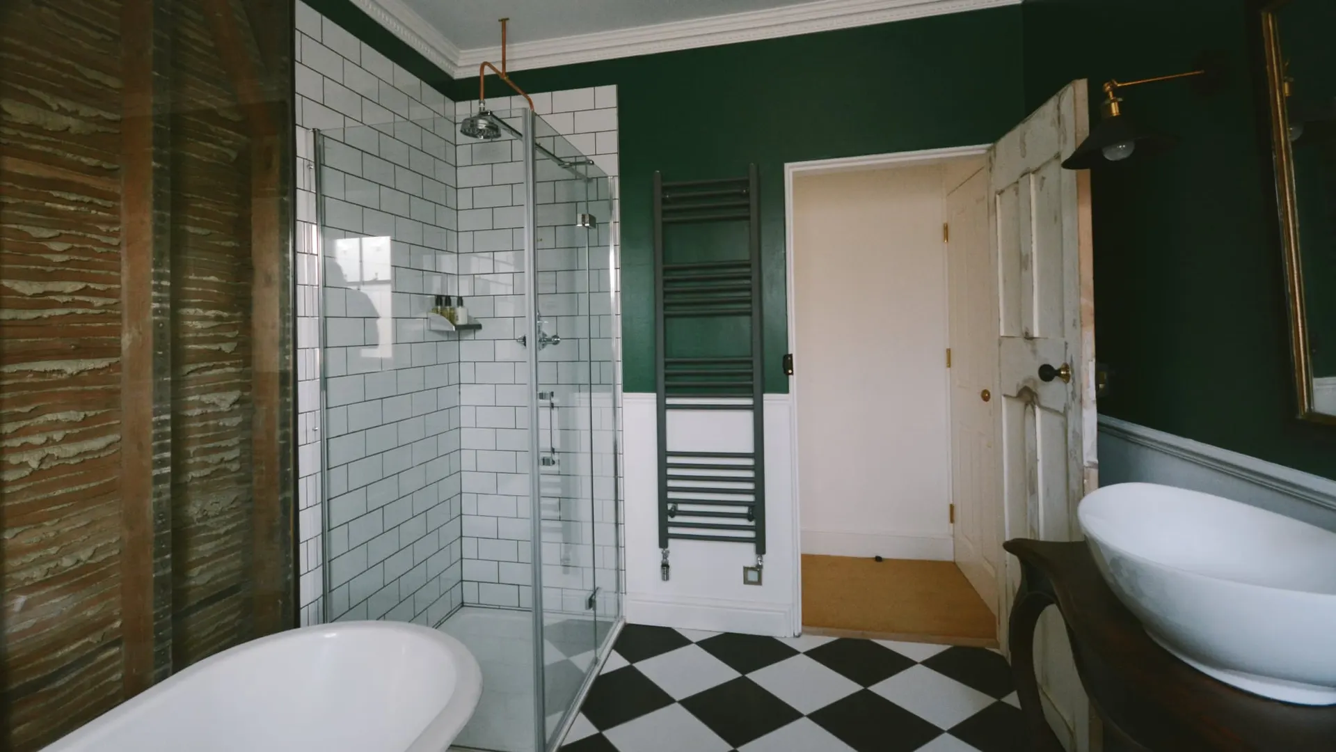 The white-tiled bathroom of the Exposed Wall room