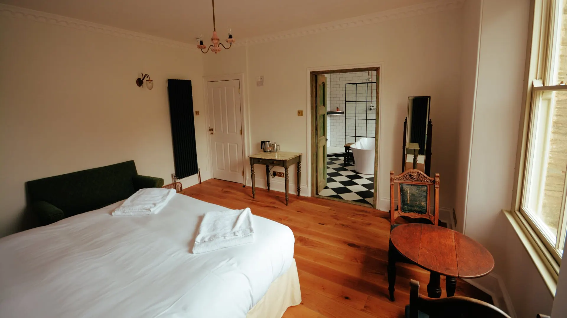 The bed in the Feature Bathroom room, looking through to the bathroom