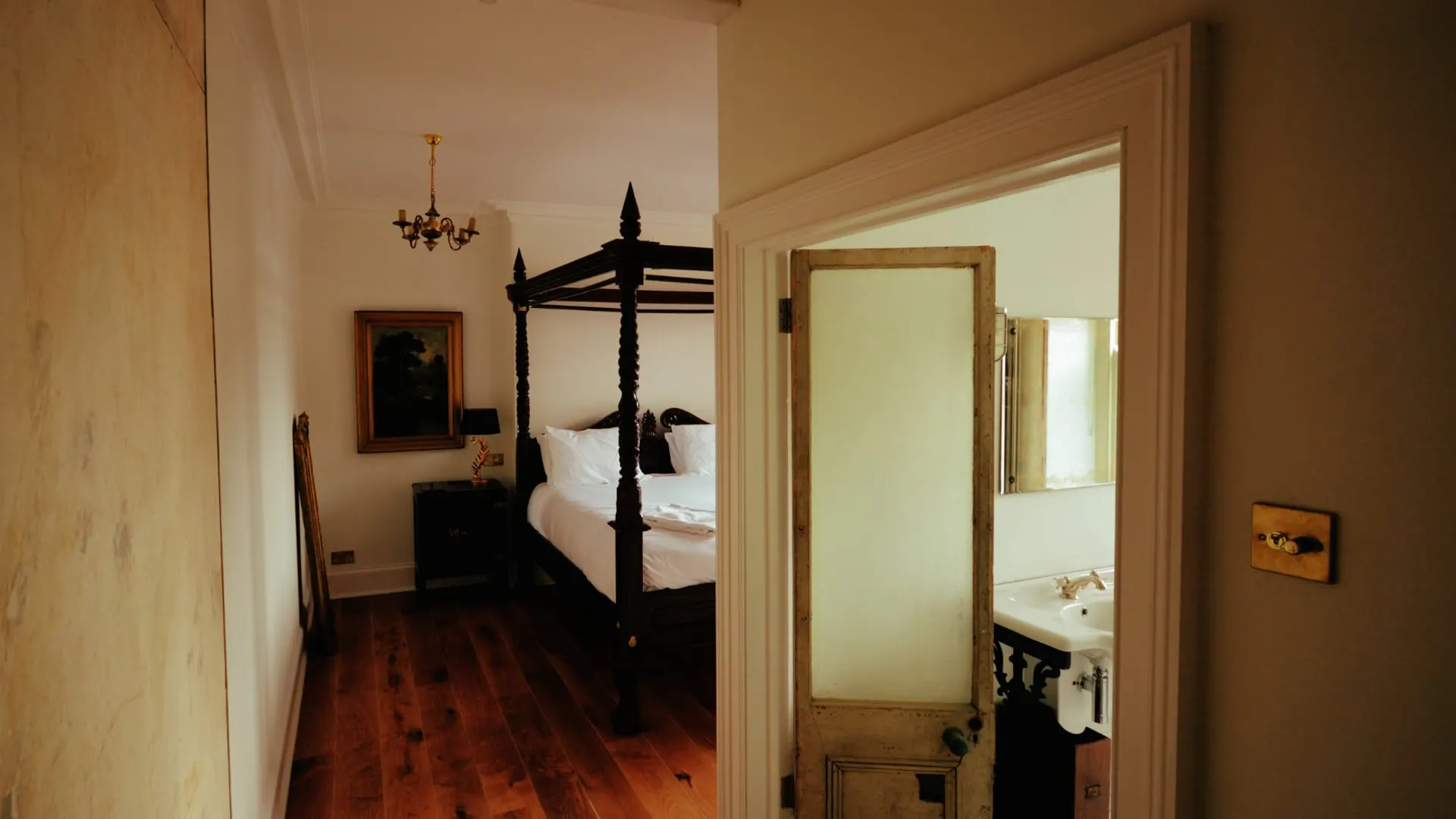 The Four Poster room seen through to the bedroom mirror