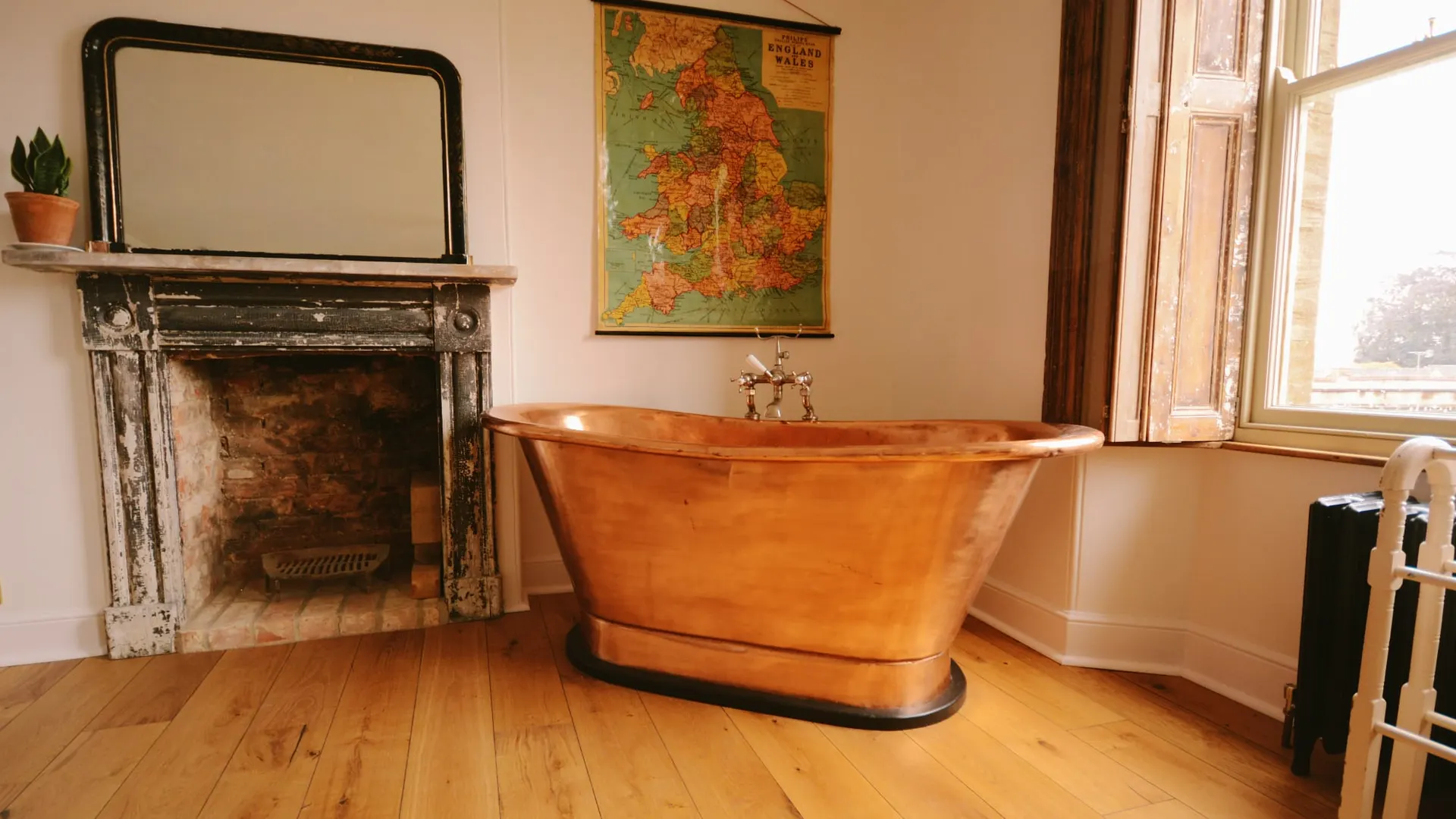 The copper bath and marble fireplace in the Honeymoon Suite